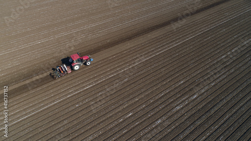 Farmers drive planters to plant Plastic Mulched peanuts in North China