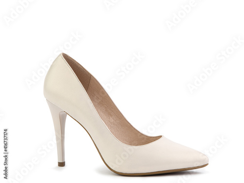 Classic and elegant high-heeled women shoes. Minimalist and stylish white shoes on high heels. Isolated object close up on white background. Right side view. Fashion shoes.