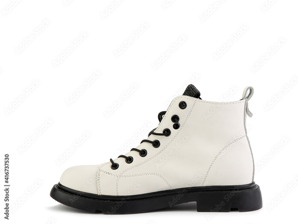 White leather ankle boots with black laces and black rubber sole. Isolated close-up on white background. Left side view. Casual seasonal shoes. Fashion shoes. White leather ankle boots with black laces and black rubber sole. Isolated close-up on white background. Left side view. Casual seasonal shoes. Fashion shoes.