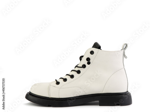 White leather ankle boots with black laces and black rubber sole. Isolated close-up on white background. Left side view. Casual seasonal shoes. Fashion shoes.