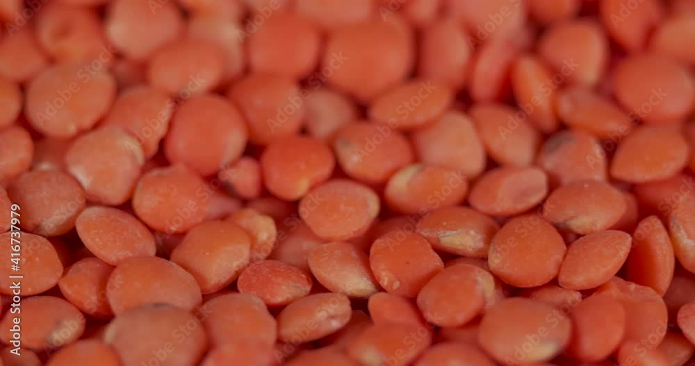 Slow Motion Rotation Red Lentils. Macro Shot Lentil Texture Pattern Background. Vegetarian Healthy Organic Food Diet. Raw Organic Red Lentils Grains Rotating Close-up. Vegetarian Healthy Food. Slow Motion Rotation Red Lentils. Macro Shot Lentil Texture Pattern Background. Vegetarian Healthy Organic Food Diet. Raw Organic Red Lentils Grains Rotating Close-up. Vegetarian Healthy Food.