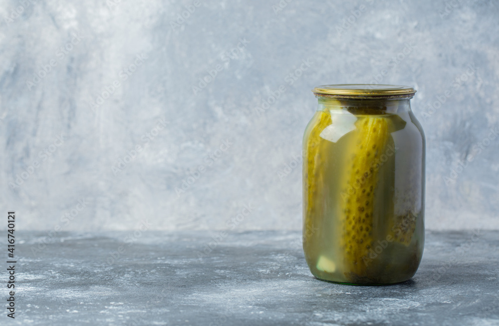 Wide angle photo of pickle jar on grey background. Wide angle photo of pickle jar on grey background.
