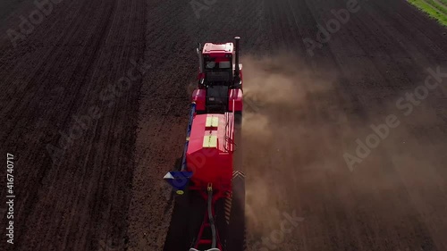 Agriculture, tractor plows the field, adjusting the soil to the sowing, top view