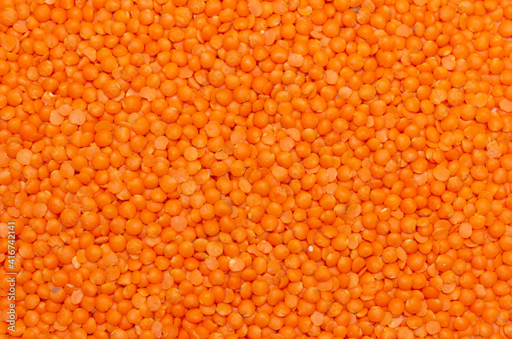 Red lentils background, lentil pattern, lentil texture top view macro