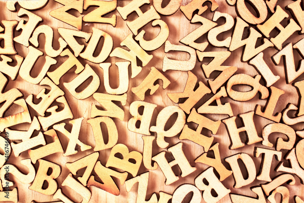 English alphabet. Wooden letters on a wooden background. English alphabet. Wooden letters on a wooden background.