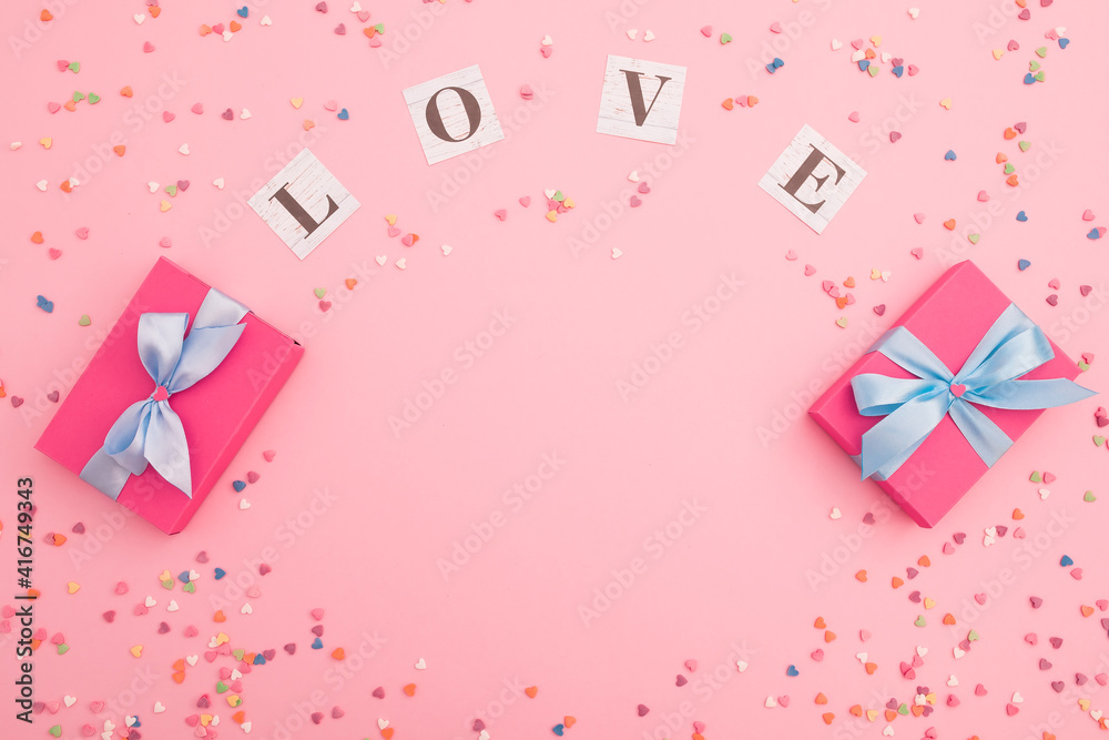 Composition with love inscription and gifts on pink background. Flat lay