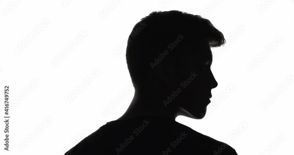 Male silhouette. Life choice. Challenge opportunity. Dark contrast back view outline of serious man turning head choosing way isolated on white empty space background. Male silhouette. Life choice. Challenge opportunity. Dark contrast back view outline of serious man turning head choosing way isolated on white empty space background.