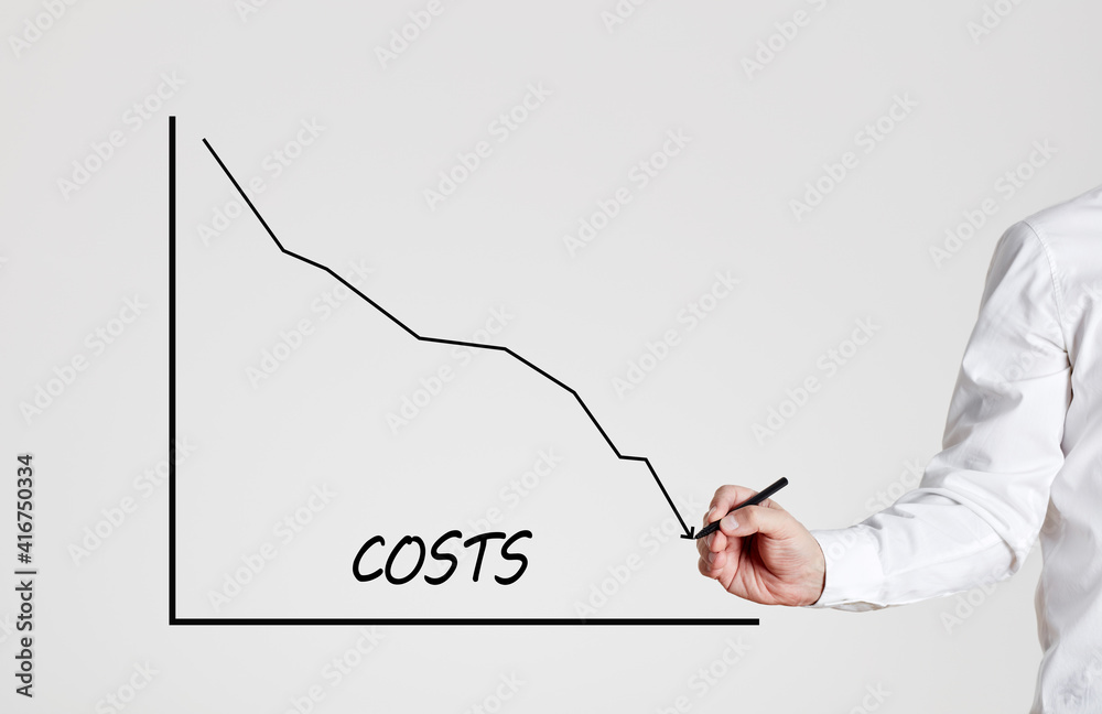 Foto de Businessman draws a declining line graph with the word costs ...