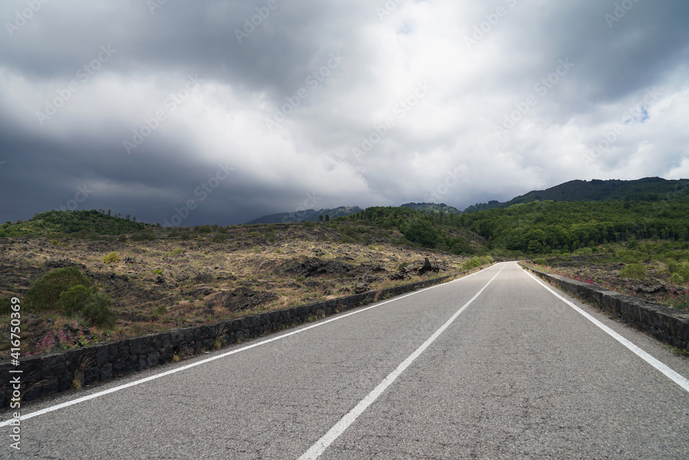 Mount Etna access road with dramatic view of Etna Mountain during dangerous volcanic eruption, Sicily, Italy