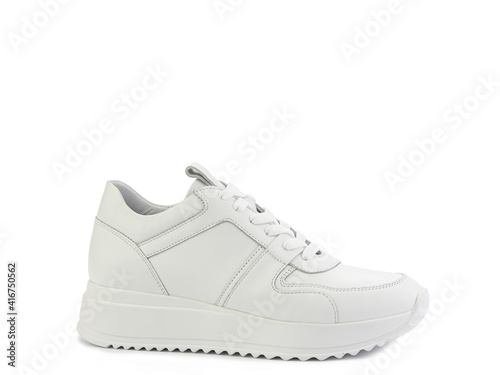 White classic leather trainers. Casual women's style. White lacing and white rubber soles. Isolated close-up on white background. Right side view. Fashion shoes.
