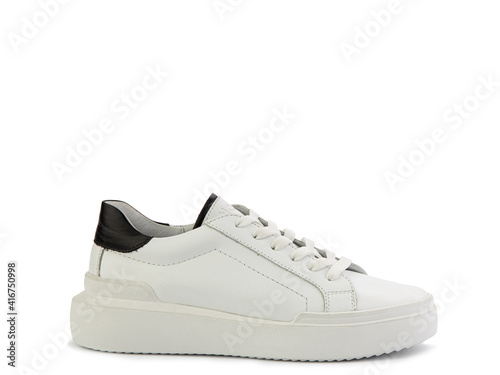 Obraz na płótnie White leather sneakers with black details. Casual women's style. White lacing and white rubber soles. Isolated close-up on white background. Right side view. Fashion shoes. w salonie