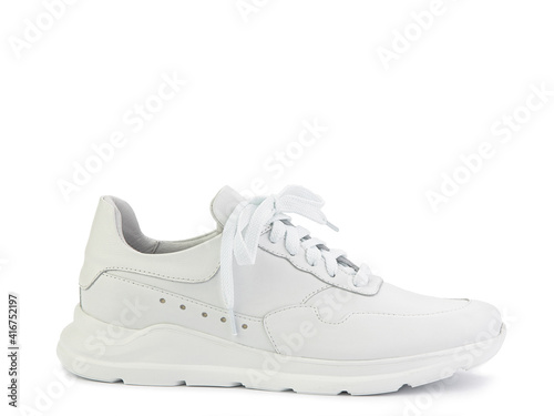 White classic leather trainers. Breathable, comfortable leather. Casual women's style. White lacing and white rubber soles. Isolated close-up on white background. Right side view. Fashion shoes.