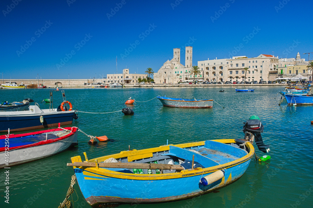 View of the old harbour of Molfetta with little colourful boats, Puglia, Italy
