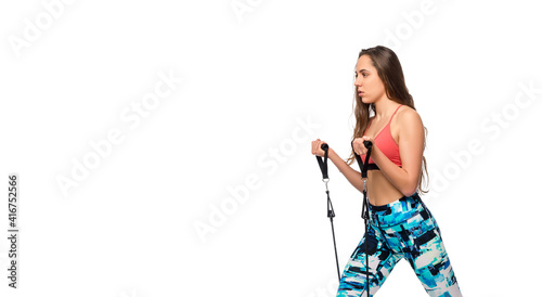 Female fitness instructor working out with a rubber resistance band on white background. Sport online concept.