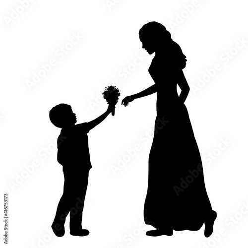 Silhouette little boy gives mom flowers . Mothers day.