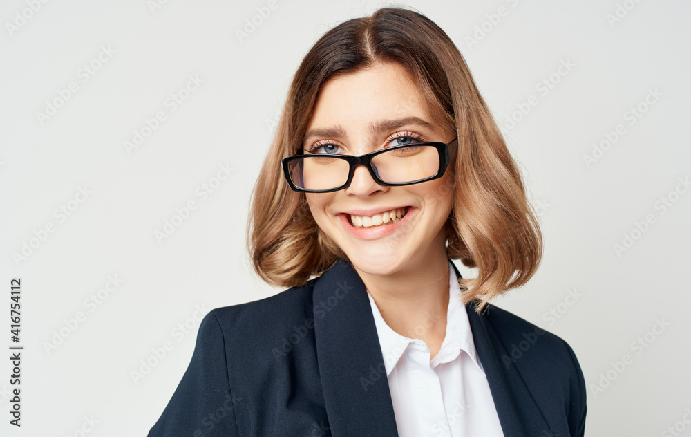 Portrait of a business woman in a classic suit and glasses on a light background cropped view