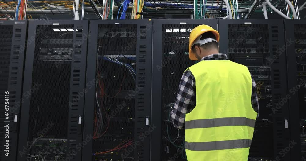 Technician man at work inside server room