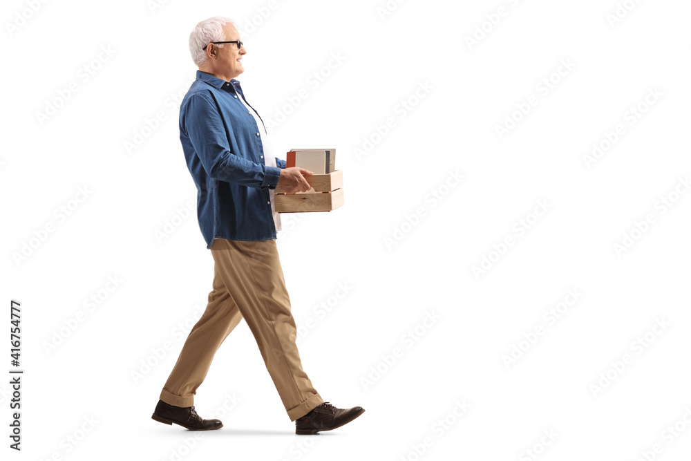 Mature man walking with a crate with books Mature man walking with a crate with books
