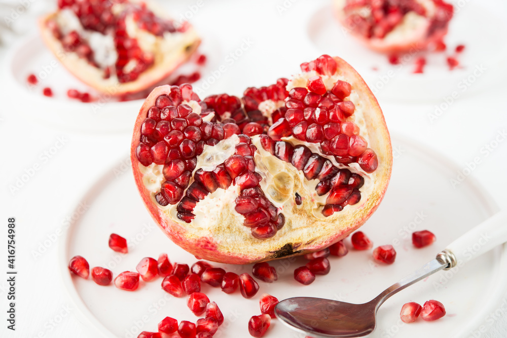 Fresh ripe pomegranate in a plate, pomegranate seeds Fresh ripe pomegranate in a plate, pomegranate seeds
