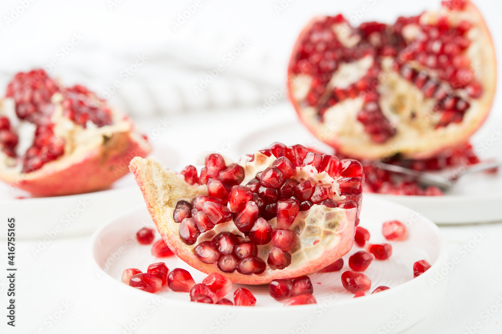 Fresh ripe pomegranate in a plate, pomegranate seeds Fresh ripe pomegranate in a plate, pomegranate seeds