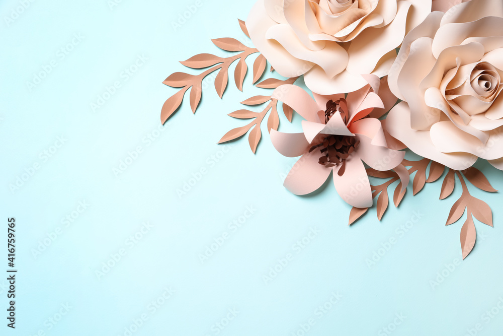 Different beautiful beige flowers and branches made of paper on light blue background, flat lay. Space for text