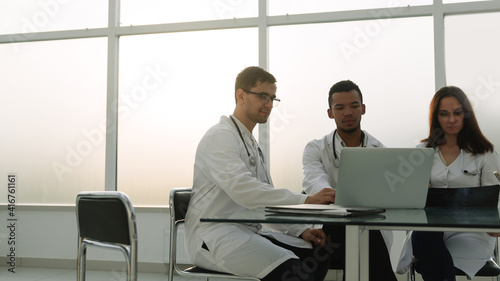 employees of the medical center sitting at his Desk .