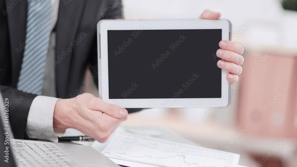 close up.businessman showing tablet with blank screen close up.businessman showing tablet with blank screen