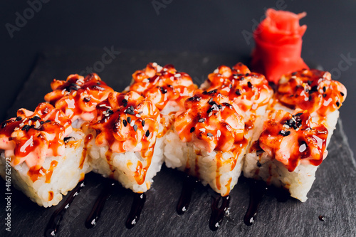 Traditional japanese food, Mix colorful sushiSet of different kinds of sushi rolls with salmon, shrimp and vegetables. On black rustic background. Top view. photo