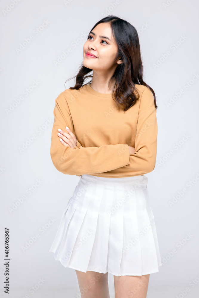 Beautiful young woman standing in casual wear , Mixed race Asian Caucasian girl. Happy face, a confident, beautiful woman isolated on a gray background. Beautiful young woman standing in casual wear , Mixed race Asian Caucasian girl. Happy face, a confident, beautiful woman isolated on a gray background.