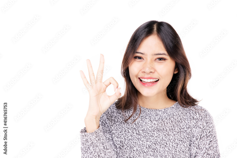 Beautiful young woman in casual wear, hands show okay symbols, Mixed race Asian Caucasian girl. Happy face, a confident, beautiful woman isolated on a white background. Beautiful young woman in casual wear, hands show okay symbols, Mixed race Asian Caucasian girl. Happy face, a confident, beautiful woman isolated on a white background.