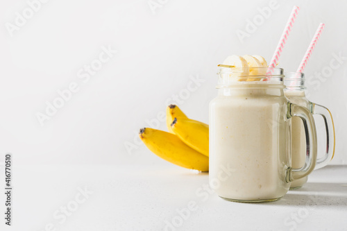 Banana milkshake on white. Close up.