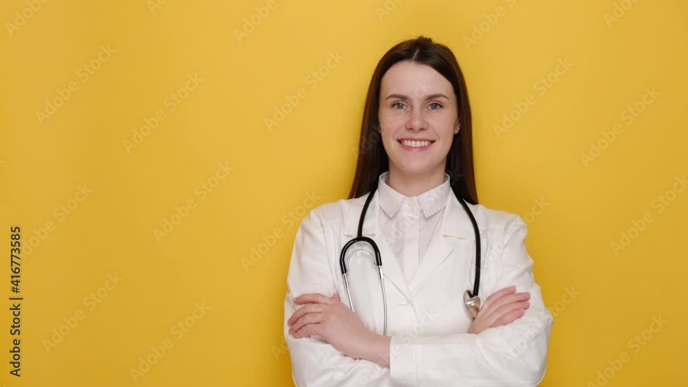 Friendly cheerful kind woman consultant apothecary qualified expert medicare help assistance, cross arms chest, isolated on yellow studio background with copy space. Doctor ready for shift in clinic Friendly cheerful kind woman consultant apothecary qualified expert medicare help assistance, cross arms chest, isolated on yellow studio background with copy space. Doctor ready for shift in clinic