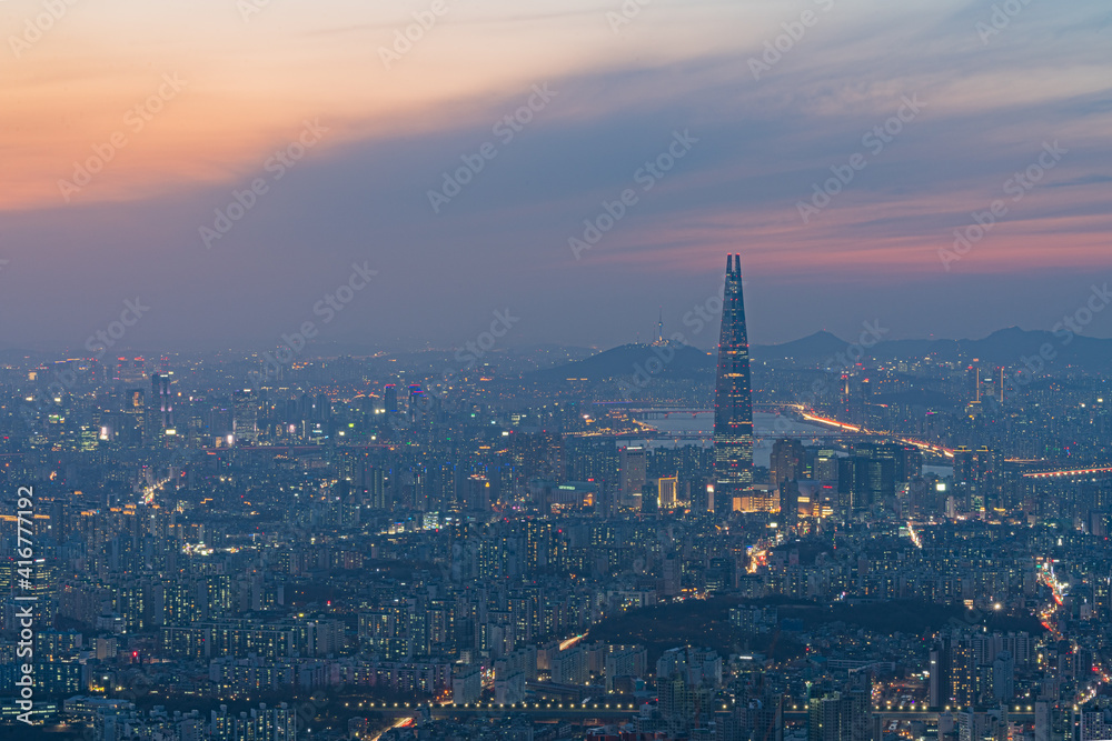 Seoul, South Korea Cityscape at Sunset. Photo shows Lotte Tower and Namsan Tower in the background.