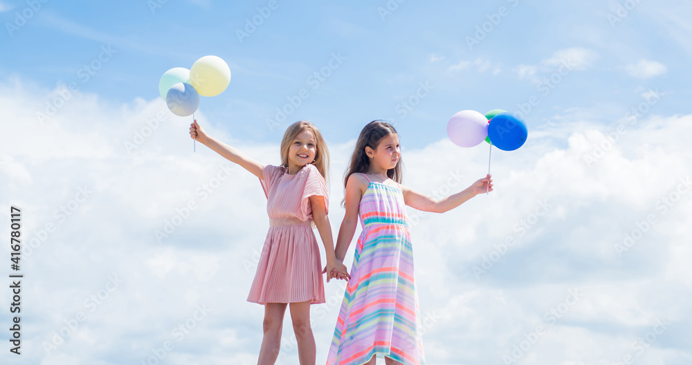 Cute and stylish. kid fashion. cheerful family day. fashion and beauty. sisterhood or friendship concept. smiling children with party balloons. childhood happiness. pretty teenage girls sisters Cute and stylish. kid fashion. cheerful family day. fashion and beauty. sisterhood or friendship concept. smiling children with party balloons. childhood happiness. pretty teenage girls sisters