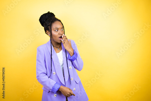 Young african american business woman covering mouth with hand, shocked and afraid for mistake. surprised expression