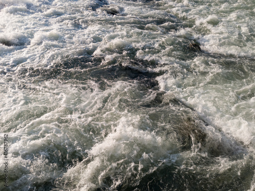 The sparkling turbulent water of the river Vrbas, rapid water movement, power of nature