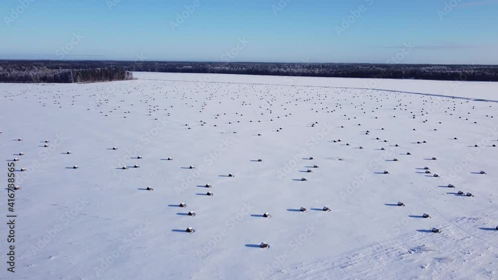Hay roll filed covered with snow aerial view low sunlight long shadows Hay roll filed covered with snow aerial view low sunlight long shadows