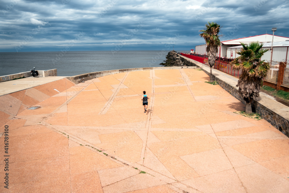 Fototapeta premium Young Man Running Near the Coast