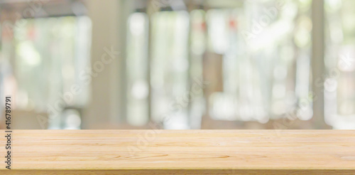 Empty wood table top with cafe restaurant window blur background