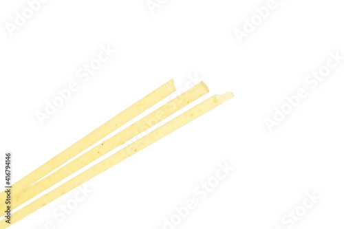 Bright yellow spaghetti, close-up, on a white background.