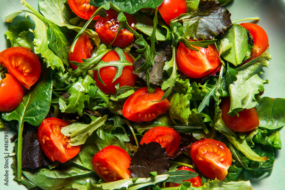 Healthy fresh salad of vegetable, tomato, spinach, arugula in plate . Food background for menu, recipe. Top view. salat with tomatoes cherry and green leafs Healthy fresh salad of vegetable, tomato, spinach, arugula in plate . Food background for menu, recipe. Top view. salat with tomatoes cherry and green leafs