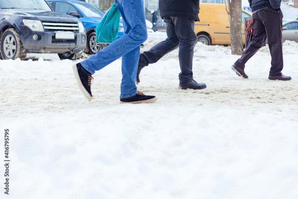 People walk in snow drifts on uncleaned street, after snow blizzard People walk in snow drifts on uncleaned street, after snow blizzard