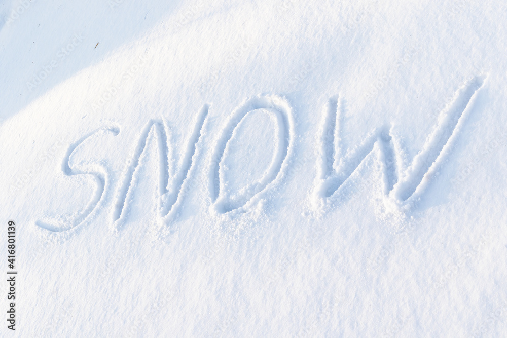 inscription on pure white snow on a frosty winter sunny day. close-up. russia
