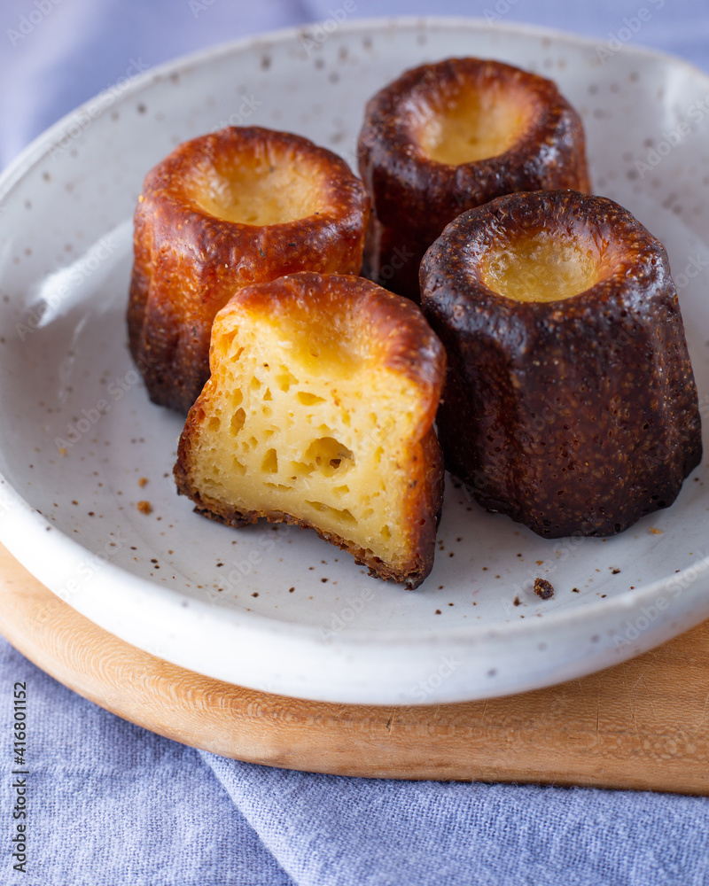 A plate of Canelés de Bordeaux A plate of Canelés de Bordeaux