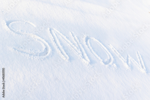 inscription on pure white snow on a frosty winter sunny day. close-up. russia