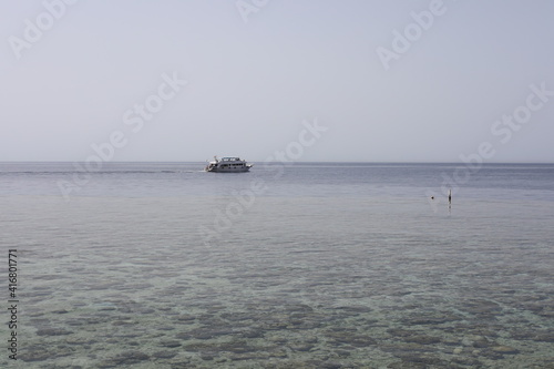 sail boat on the sea. Scenic seascape with swimming yacht near the coral reef in the Red Sea. Landscape of Egyptian coral coast and transparent clean water.  © Liudmyla Leshchynets