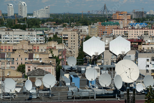 Satellite dishes on house roof photo