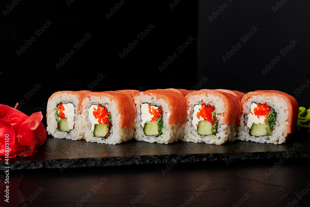 rolls on a black board on a dark textured background rolls on a black board on a dark textured background