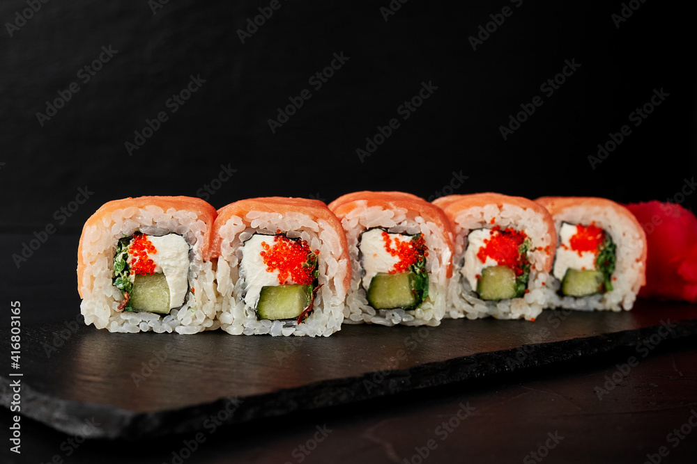 rolls on a black board on a dark textured background