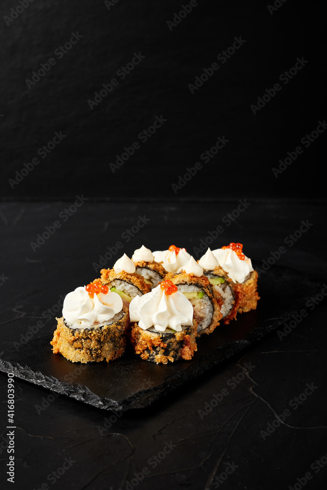 rolls on a black board on a dark textured background